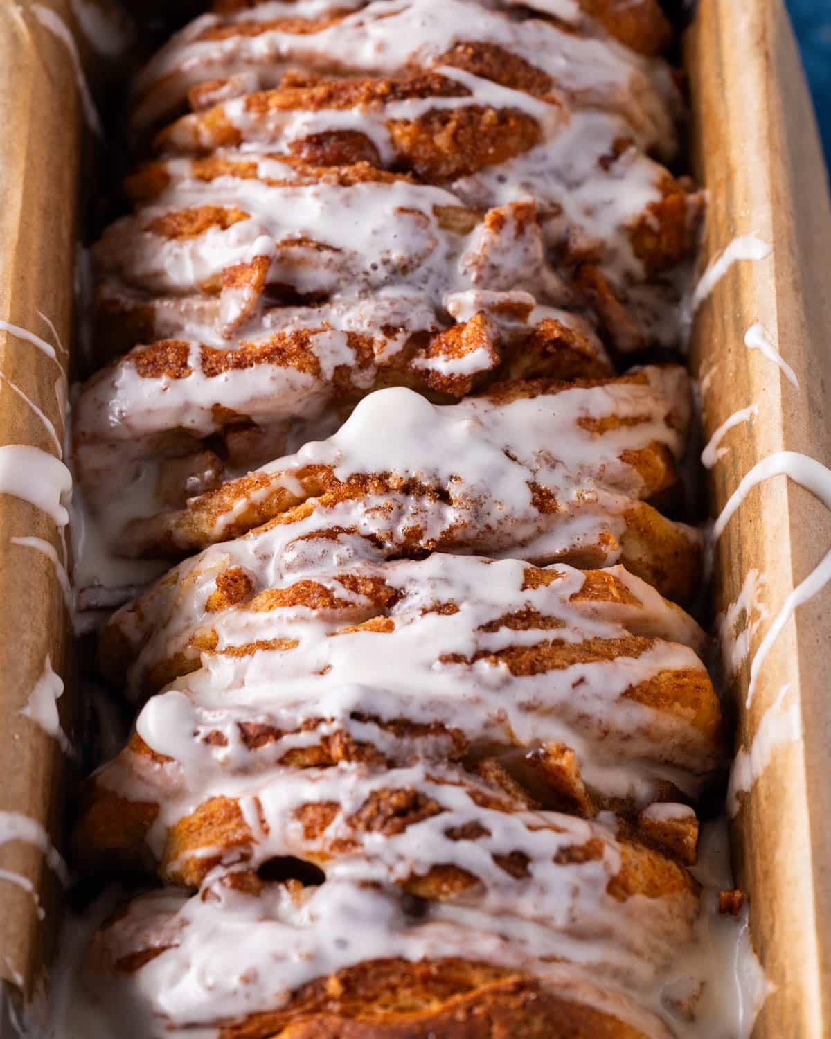 closeup of glazed pull apart bread in a pan