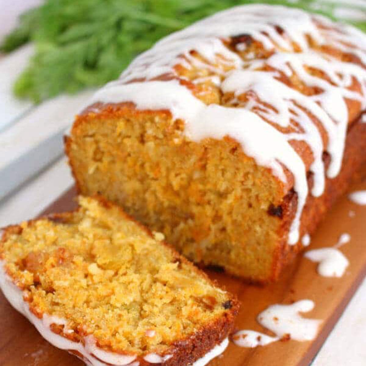 a loaf of carrot cake bread on a cutting board