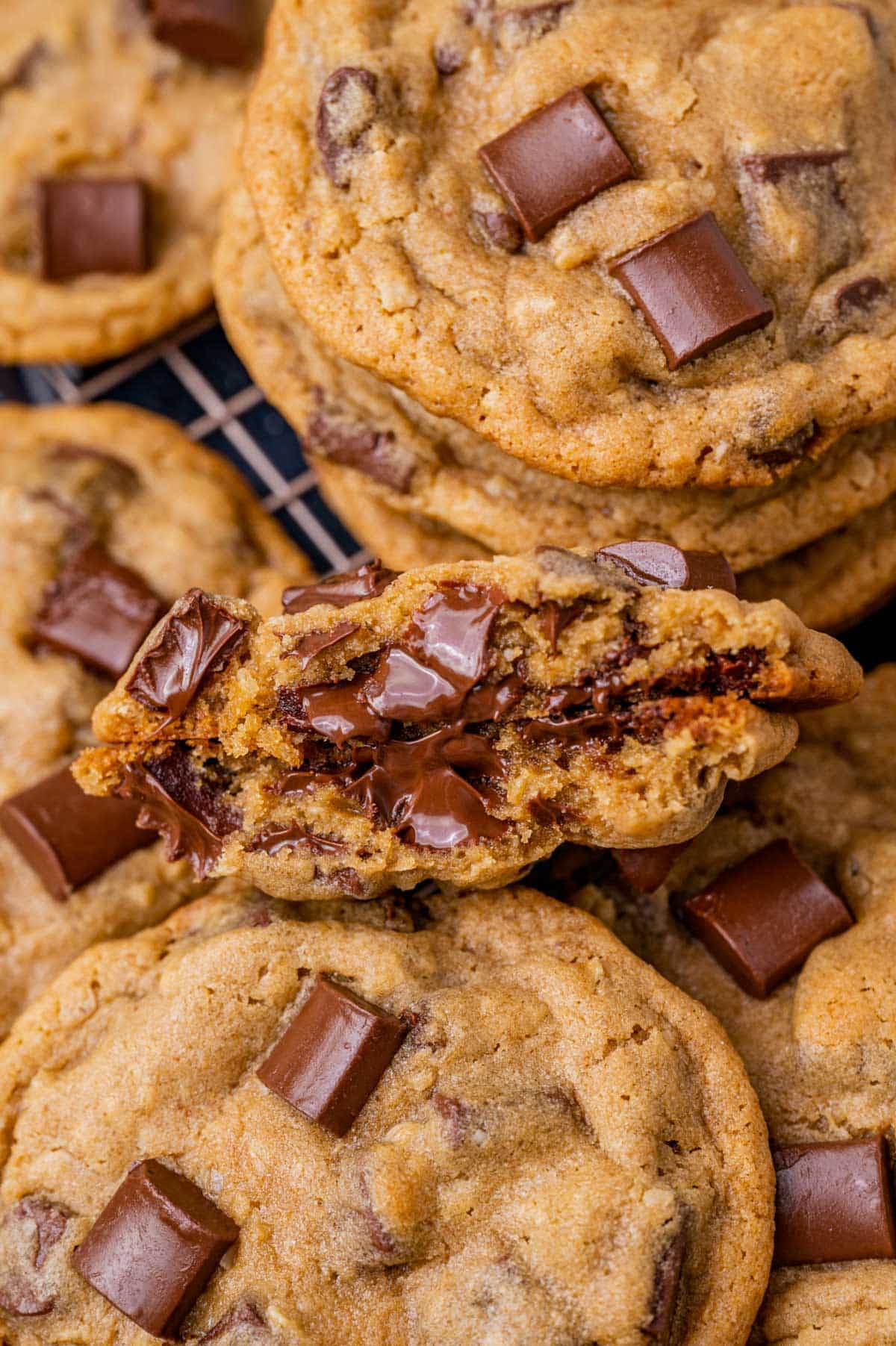 a cookie broken in half with melted chocolate chips