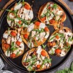 overhead view of chicken caprese pizzas on a skillet