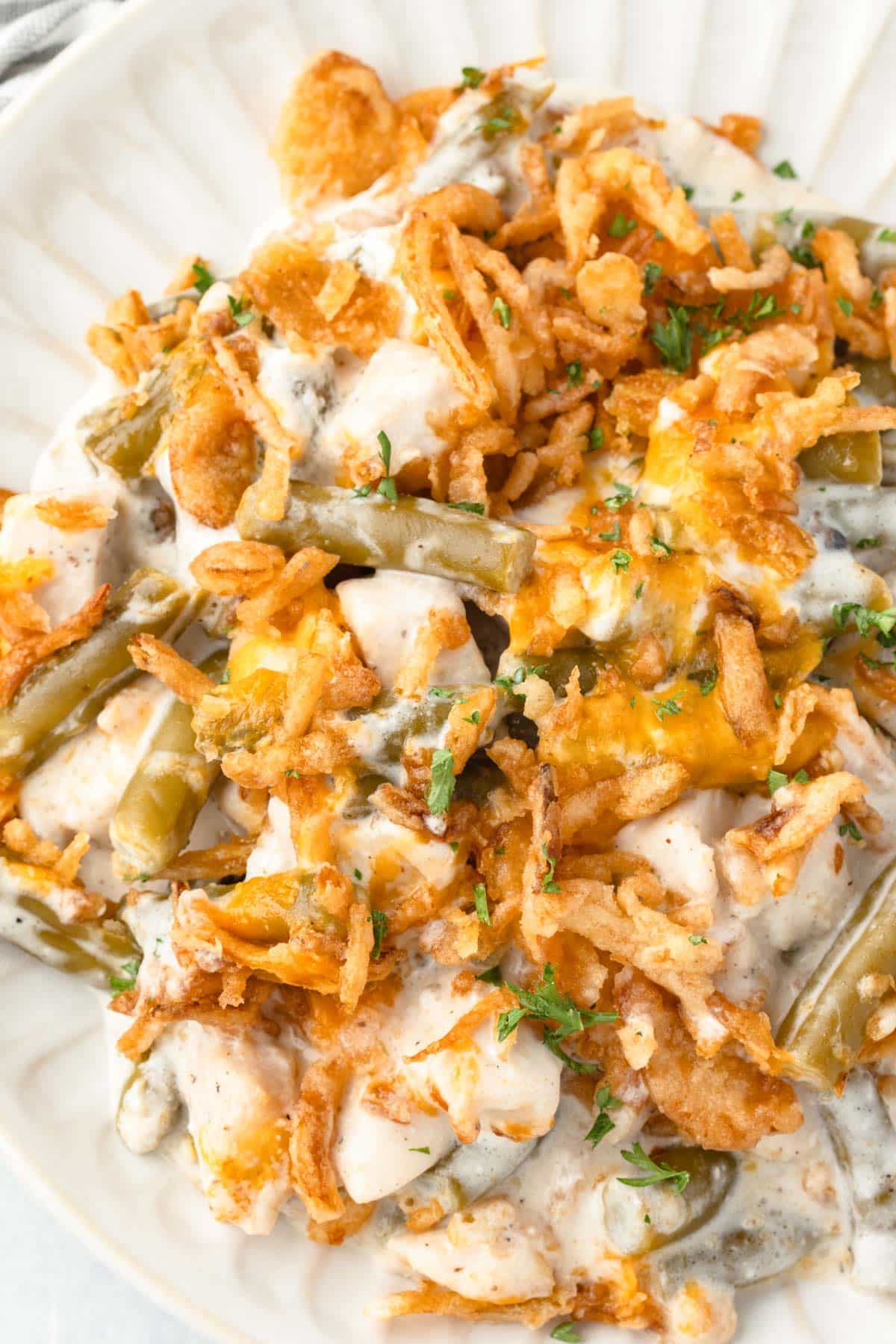 a plate of green beans, creamy chicken and french fried onions