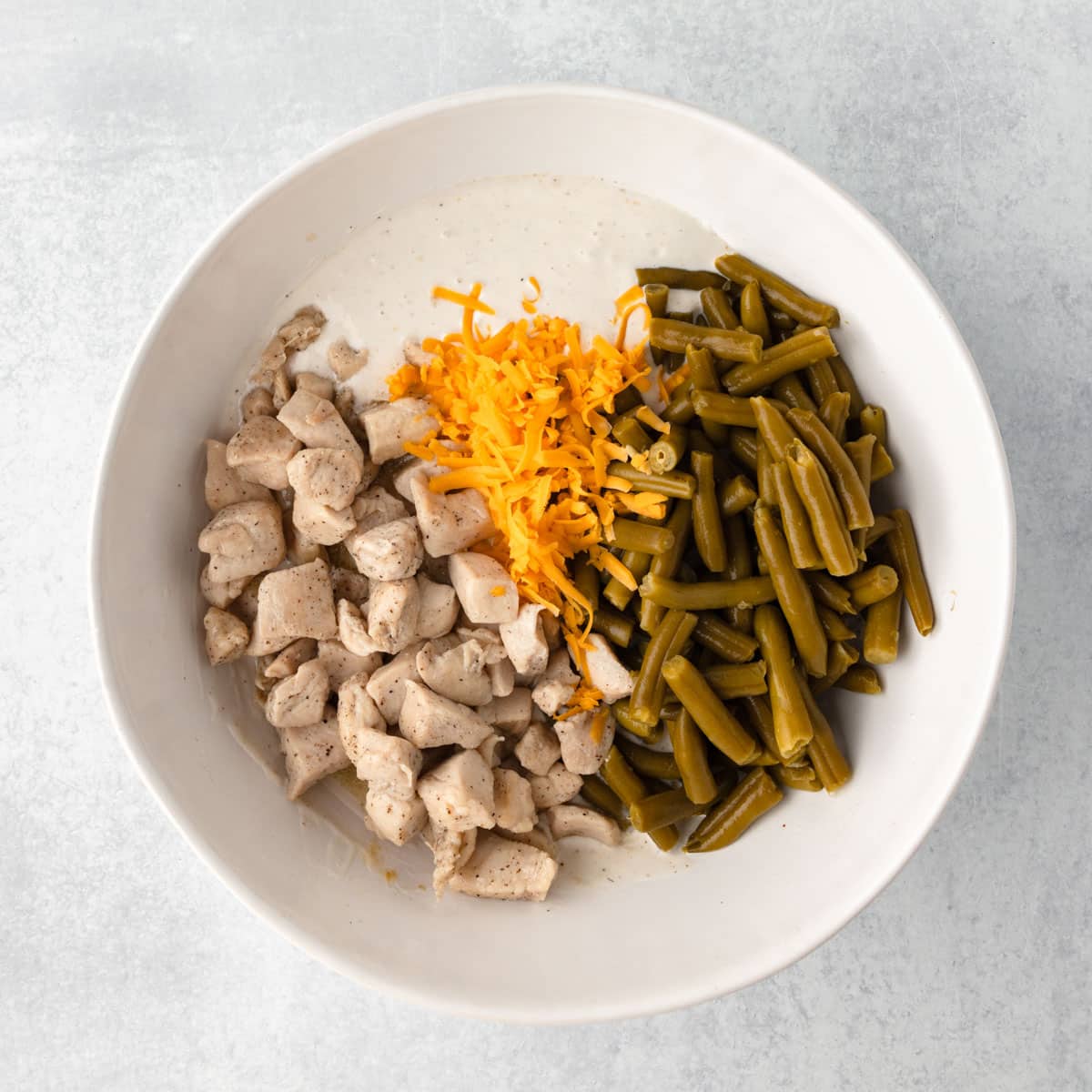 ingredients for chicken green bean casserole in a bowl