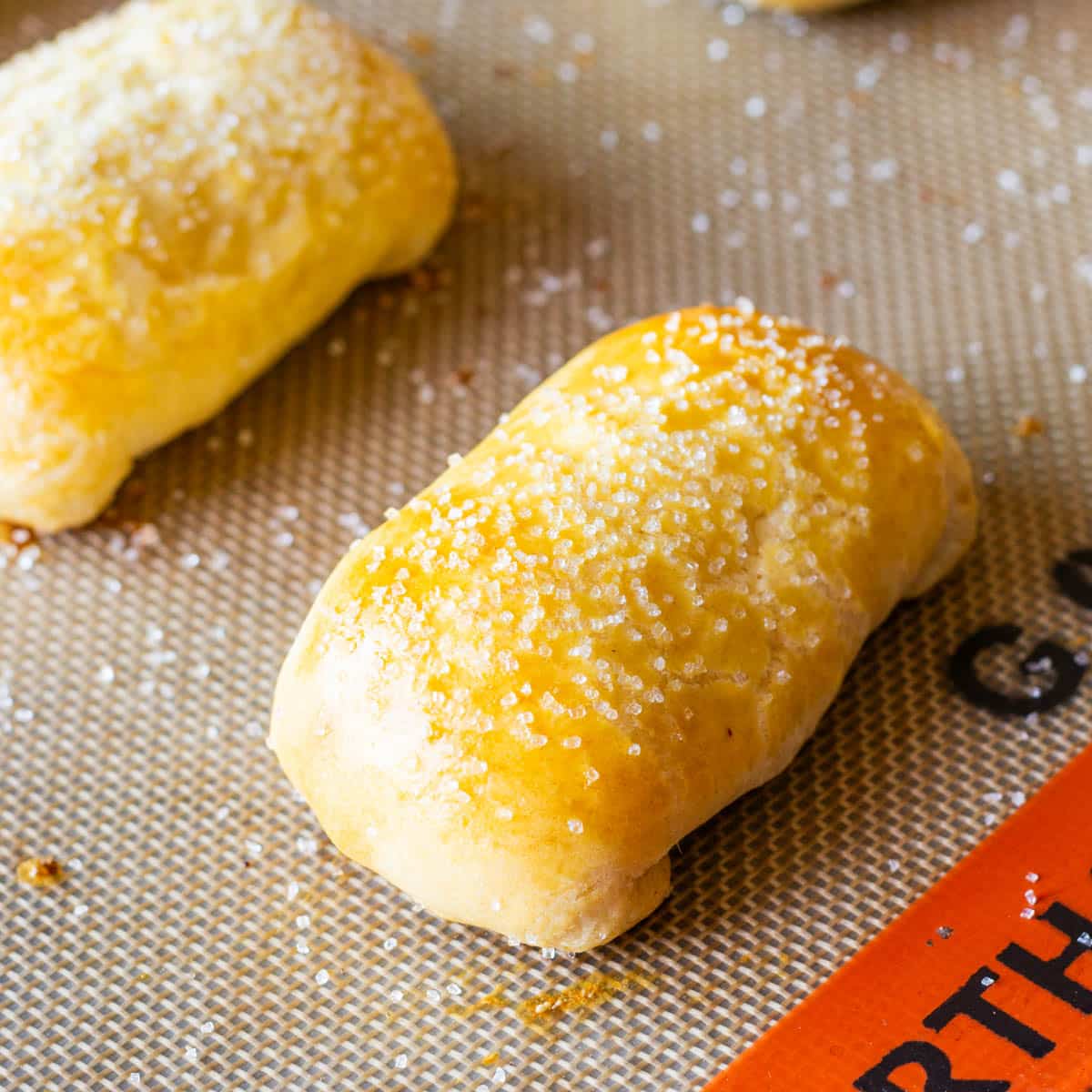 baked cinnamon cream cheese puffs on a baking mat