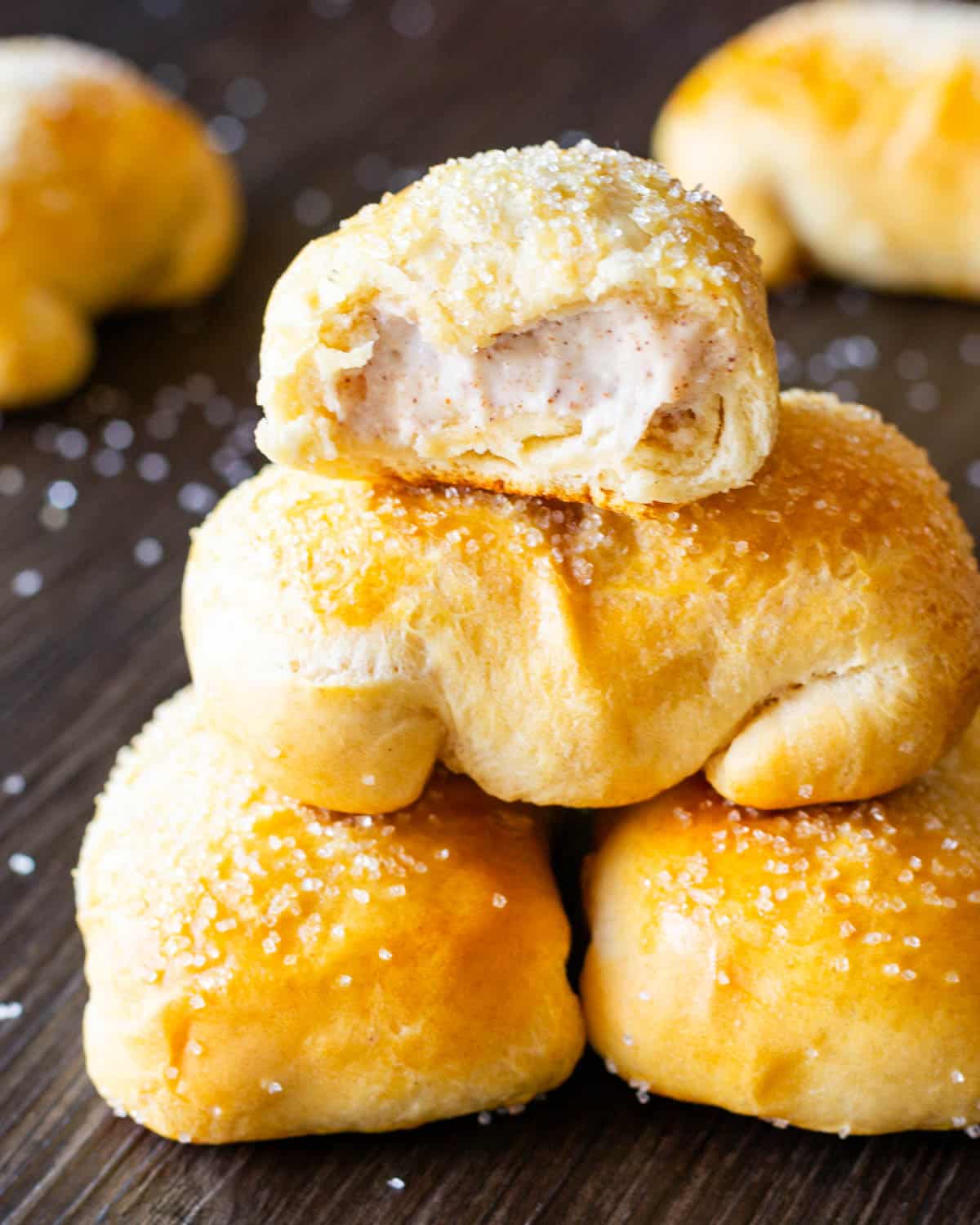 a stack of cream cheese pastry puffs with one cut in half