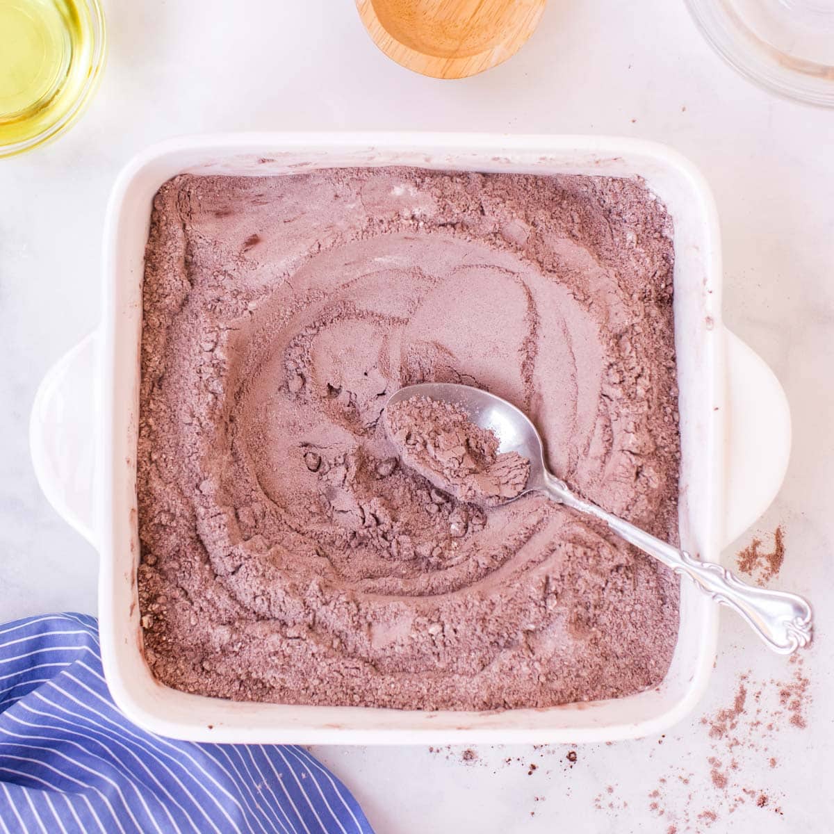 dry ingredients for cake in a pan with a spoon