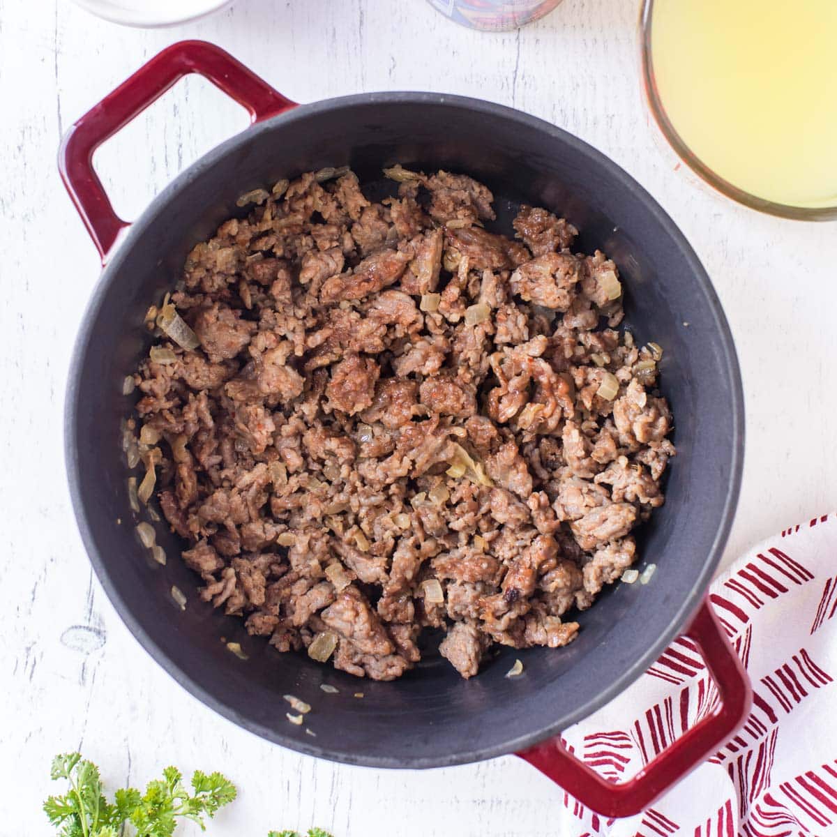 italian sausage and onions in a dutch oven