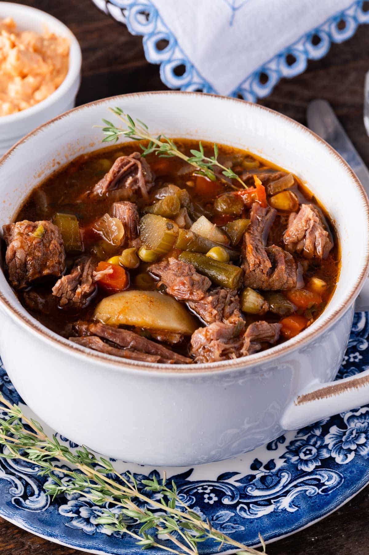 a bowl of sopu with beef and vegetables