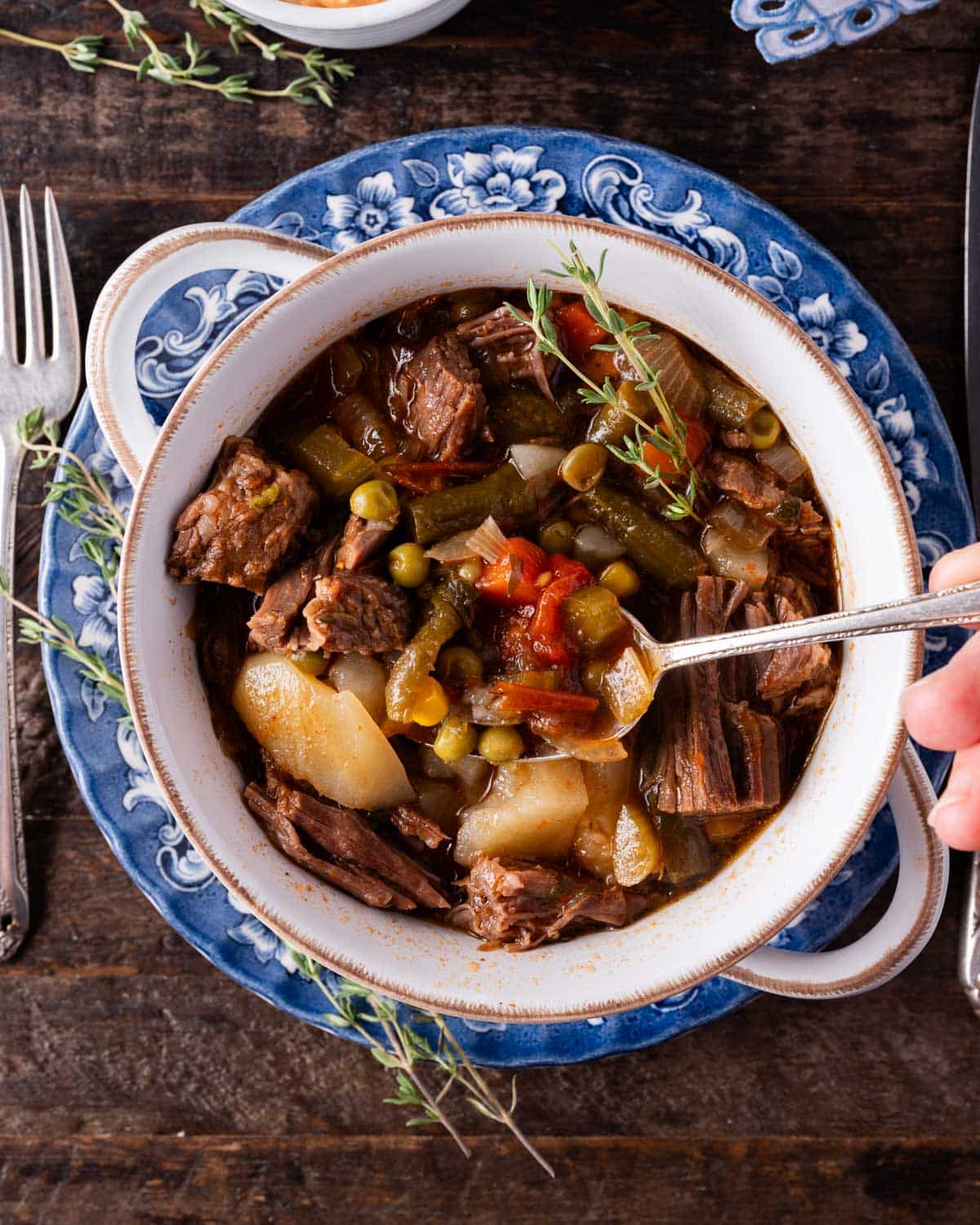 a spoon in a bowl of vegetable soup