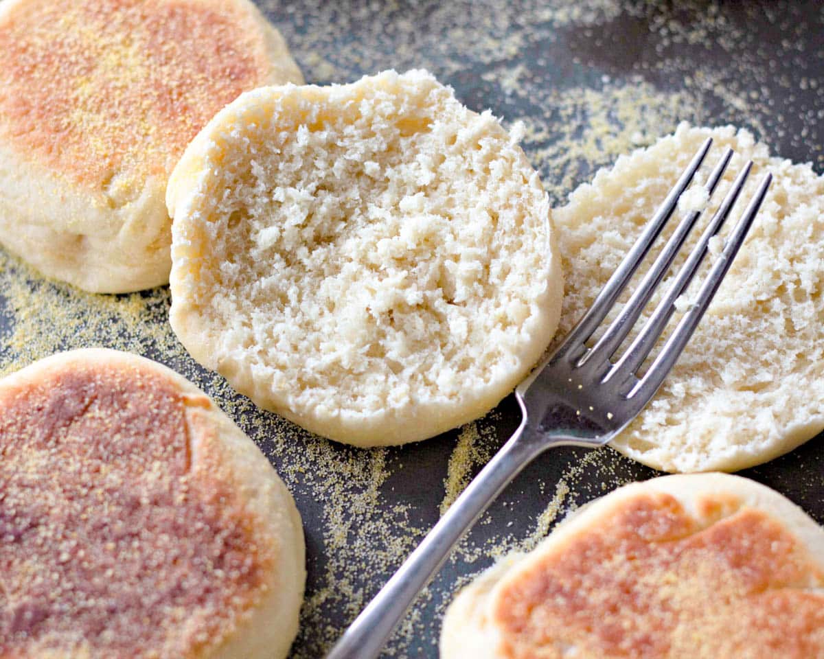 an english muffin cut in half on a baking sheet