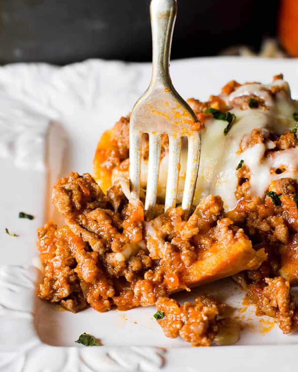 a fork cutting into an Italian sloppy joe sandwich