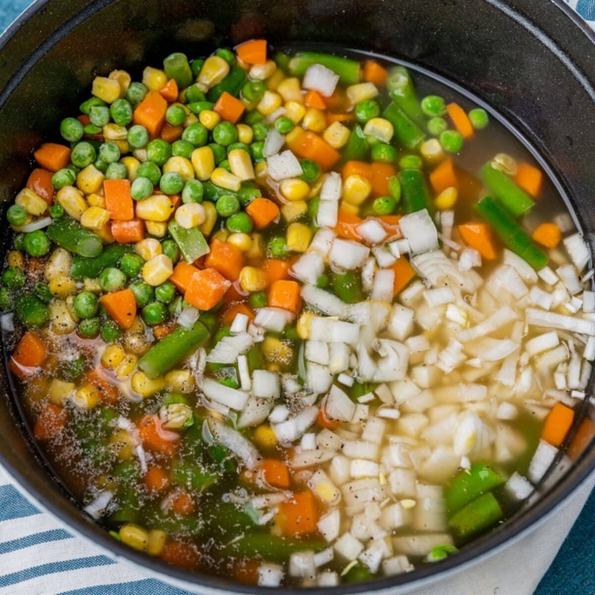 vegetables in broth in a dutch oven