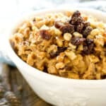 a bowl of hearty oatmeal with raisins and nuts