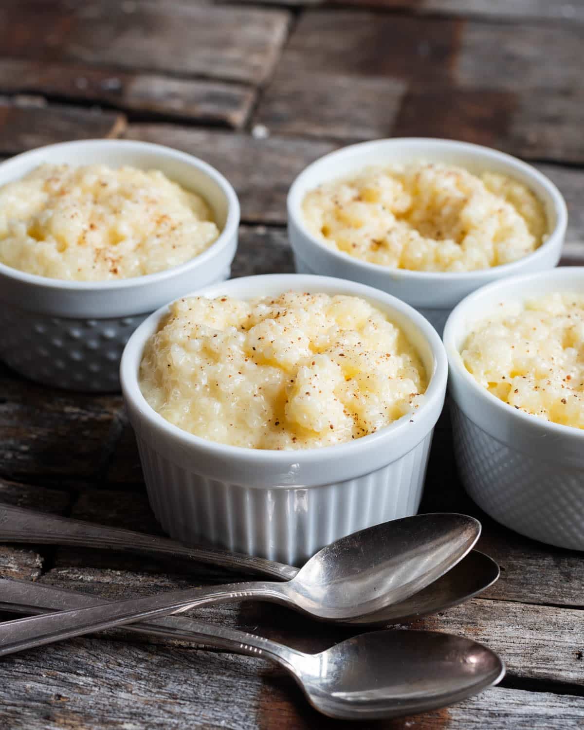 4 bowls of tapioca pudding with quick cooking tapioca on a table