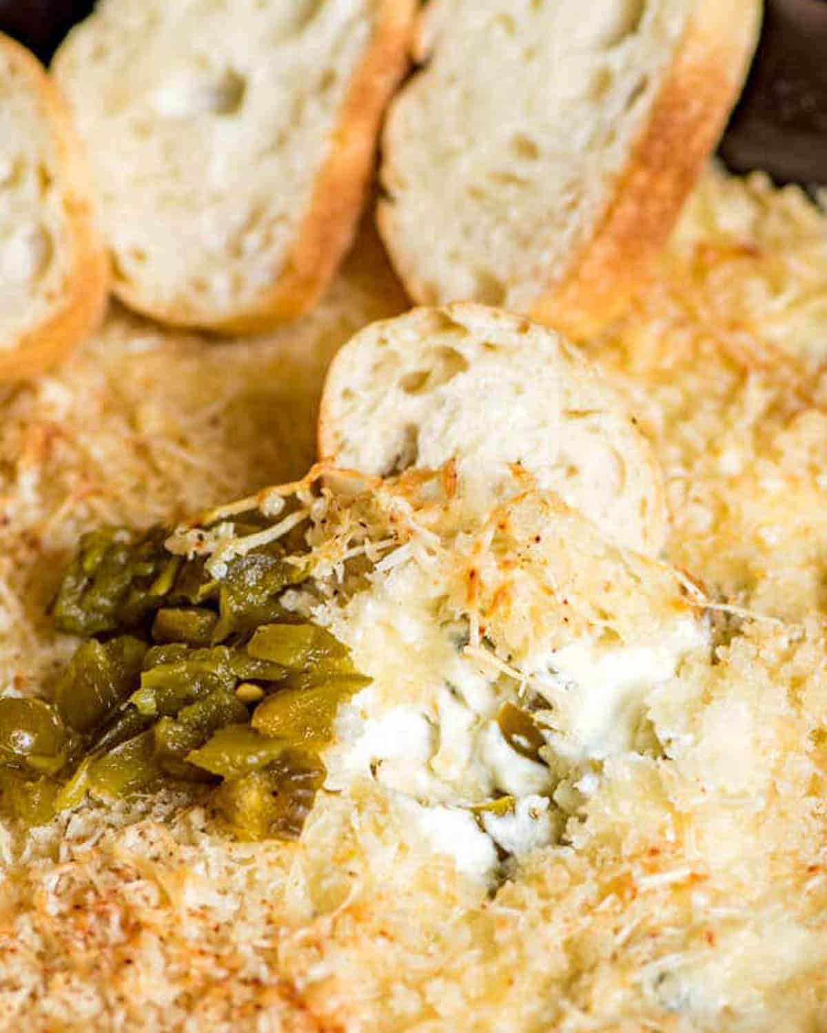 scooping bread into jalapeno popper dip