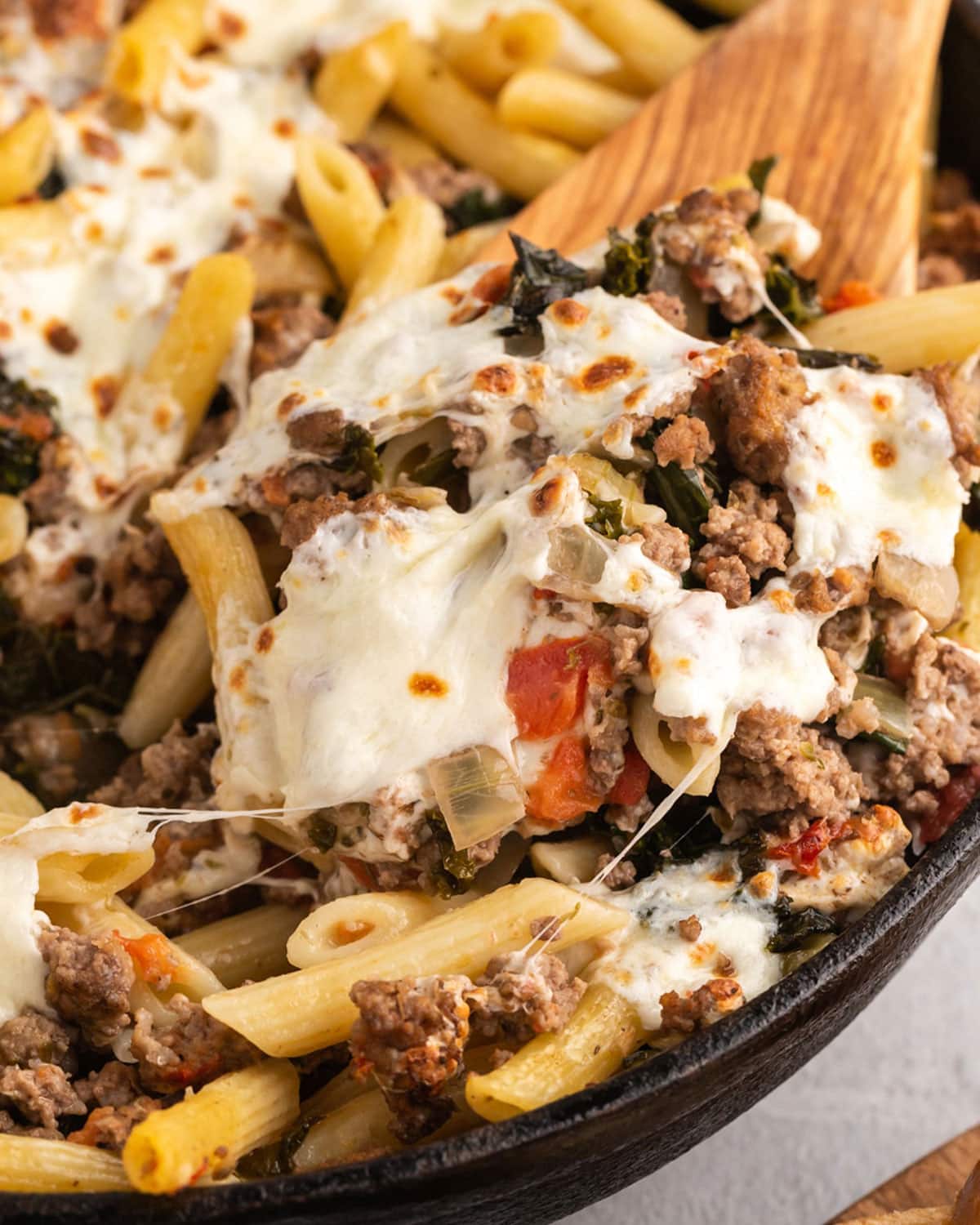 kale tomato pasta in a skillet