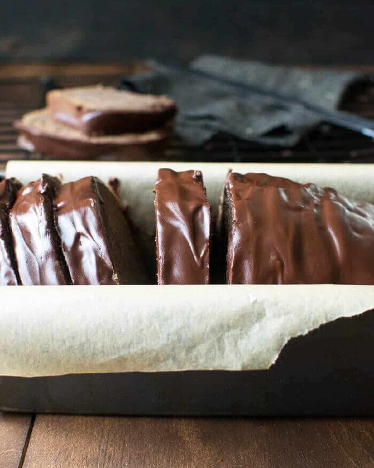 a loaf of chocolate pound cake sliced in a pan