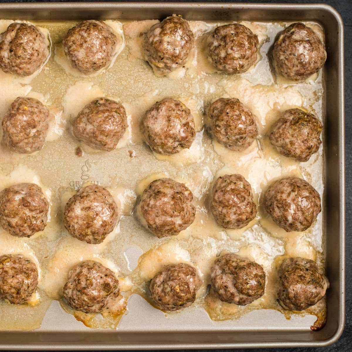 cooked meatballs on a baking sheet