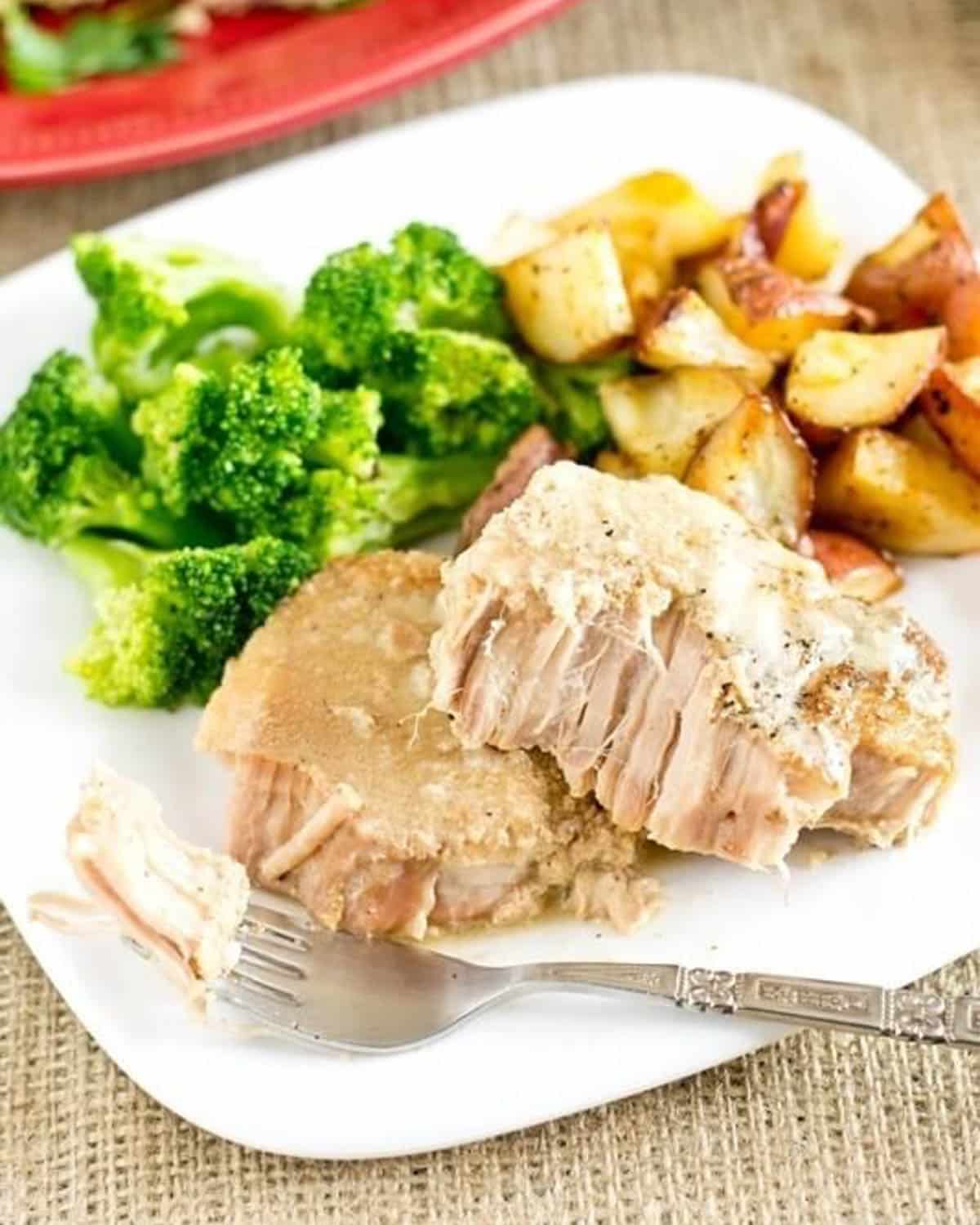 pork chops on a plate with broccoli and potatoes