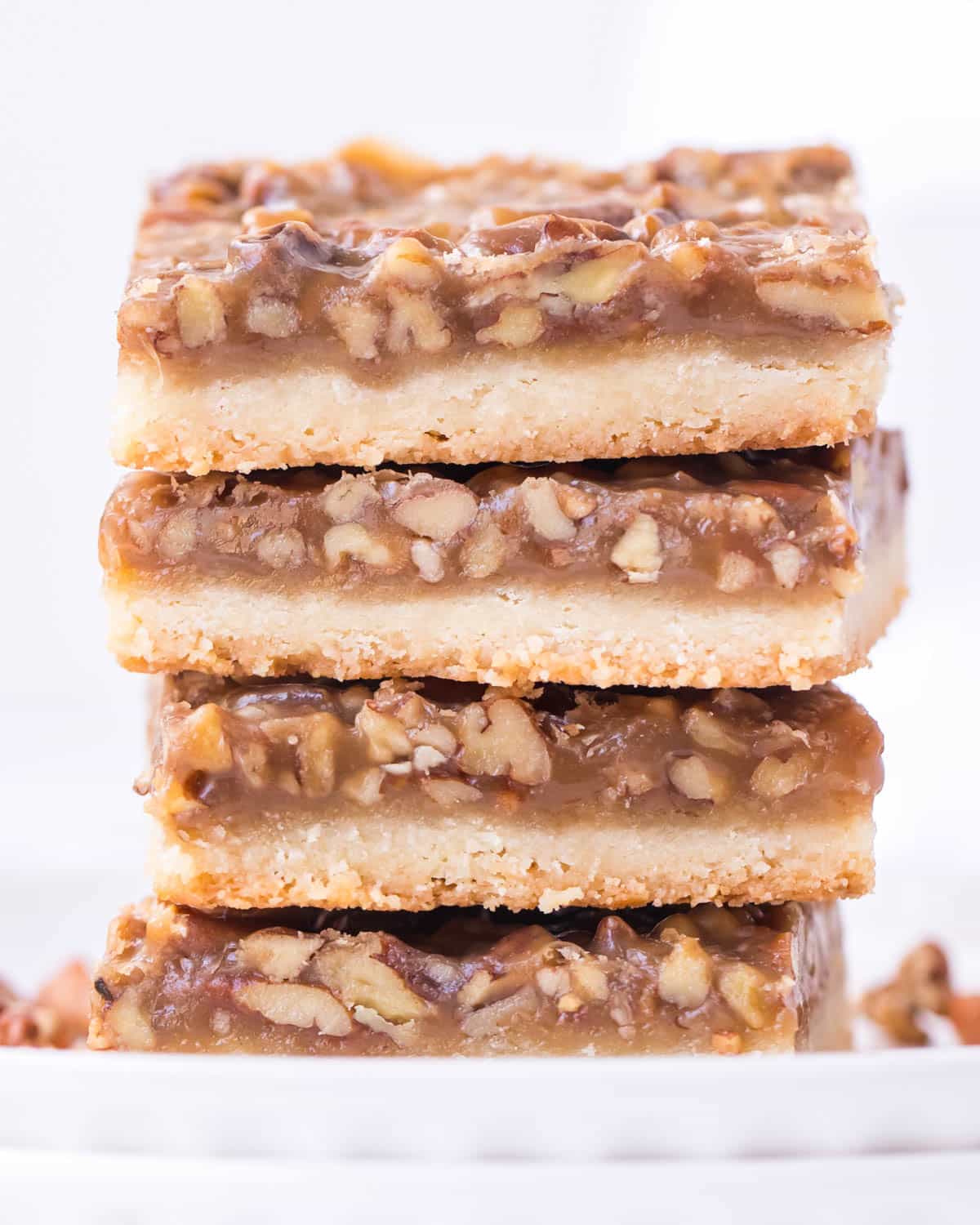 a stack of pecan bars with shortbread crust