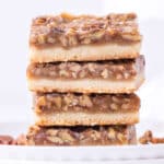 a stack of pecan bars with shortbread crust