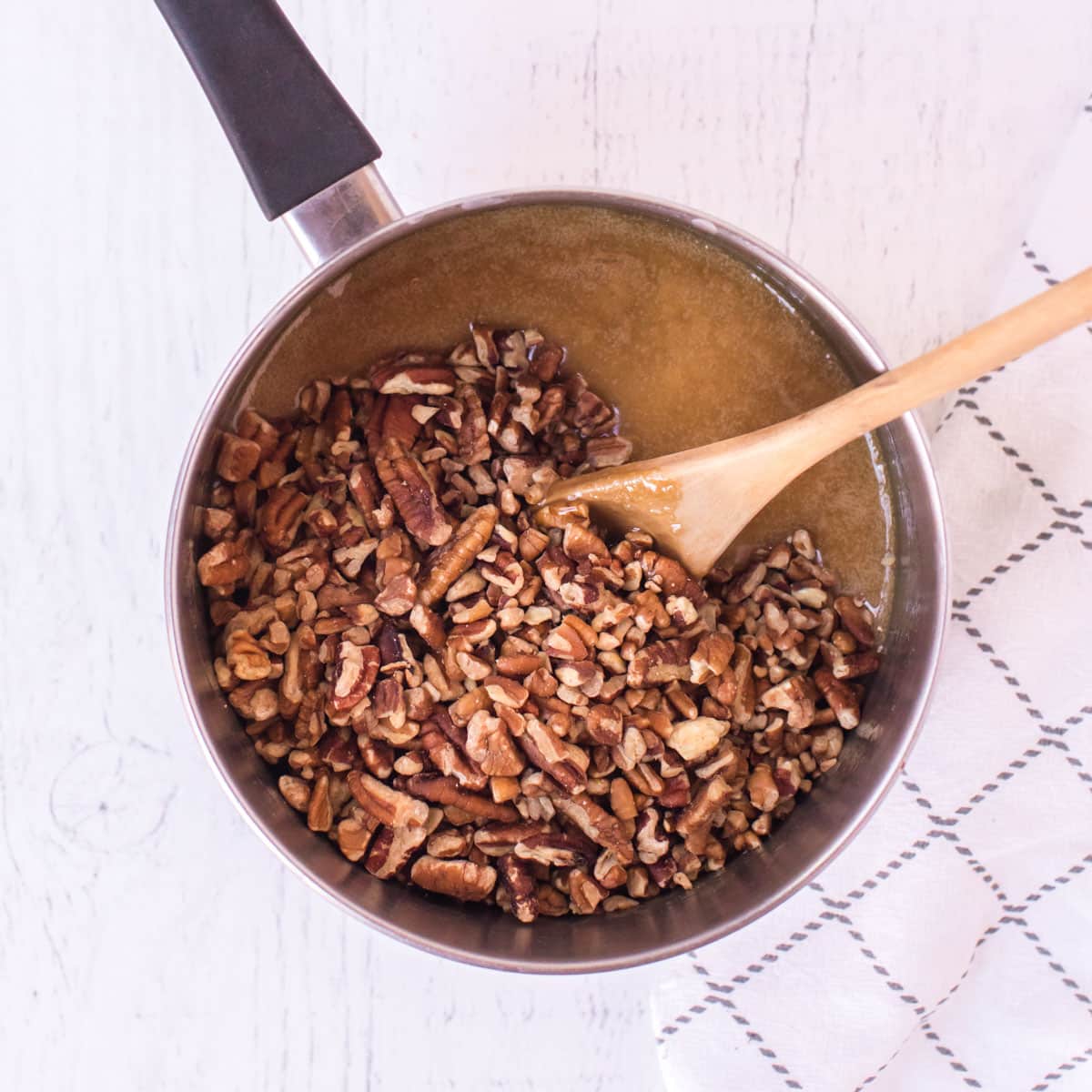 pecans in caramel sauce in a saucepan