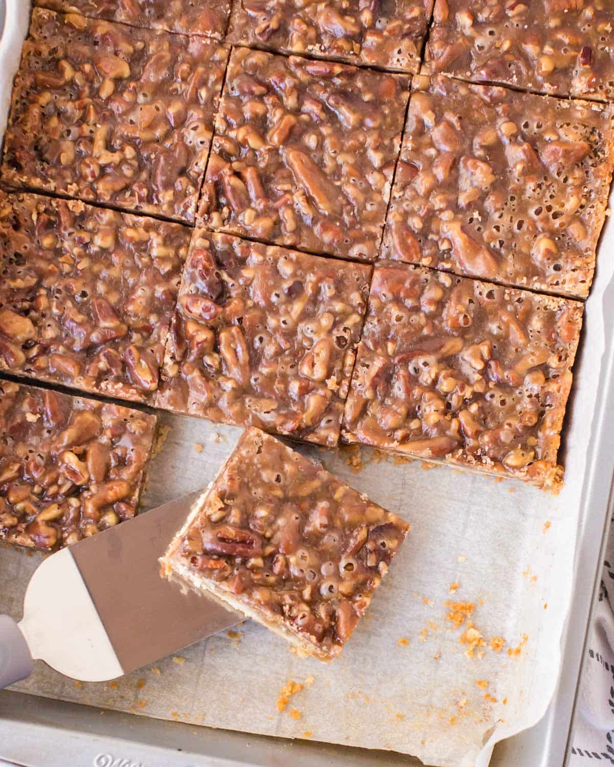 overhead view of pecan pie bars in a baking sheet