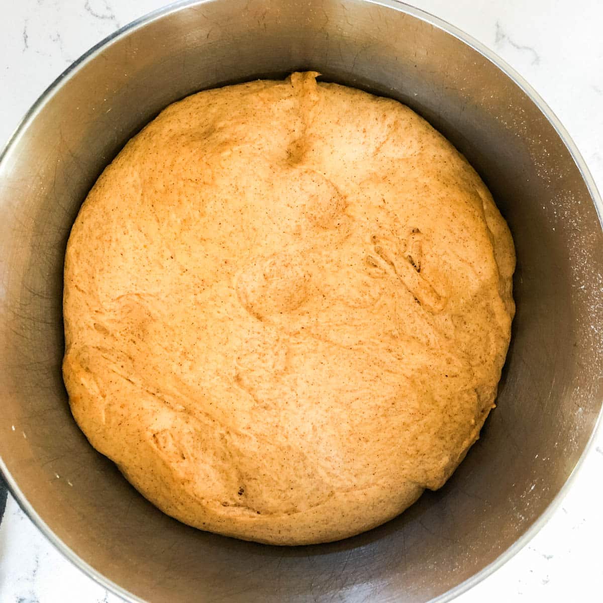 a bowl of pumpkin spice dough