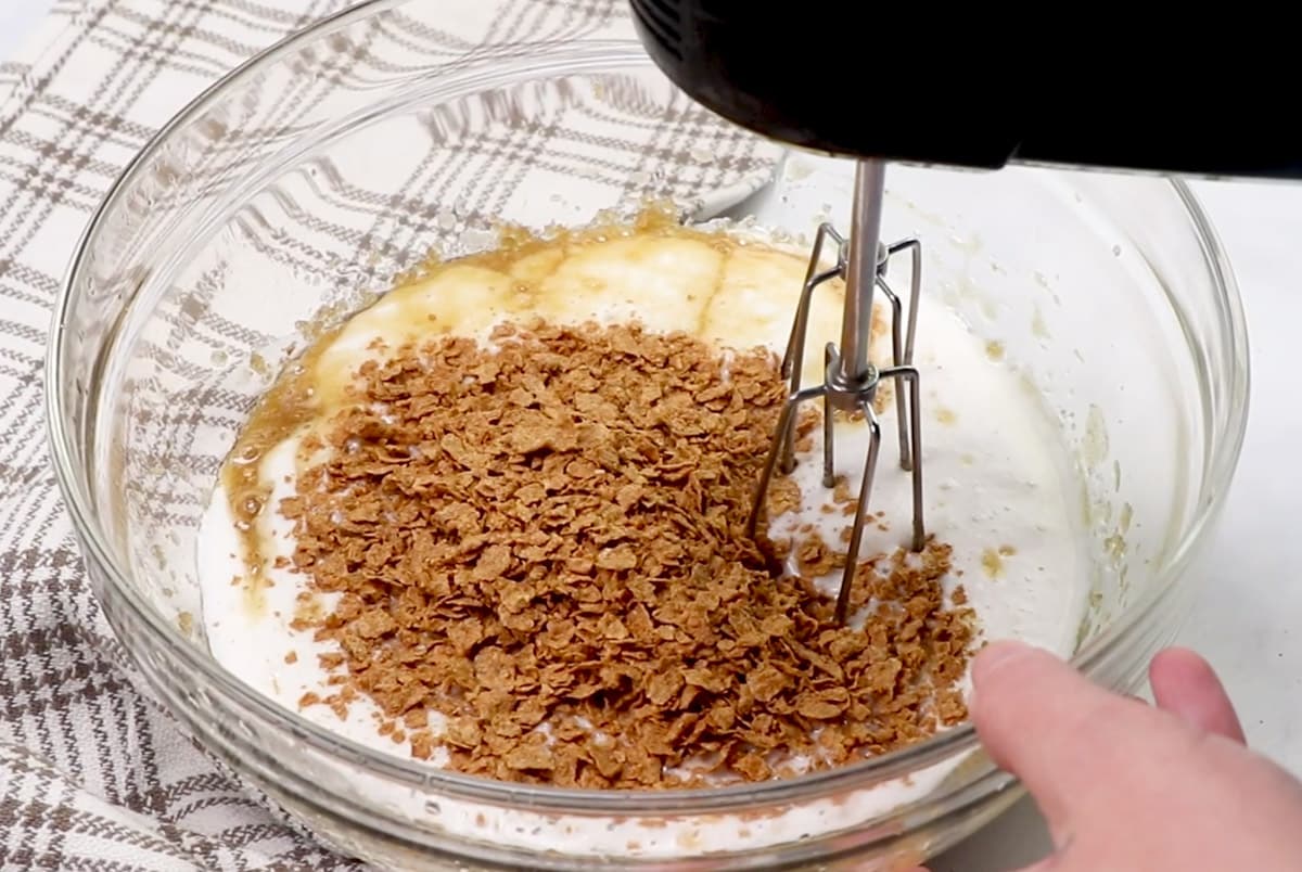 bran flakes in wet ingredients in a mixing bowl