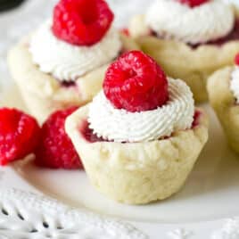 closeup of raspberry tarts with mascarpone cream