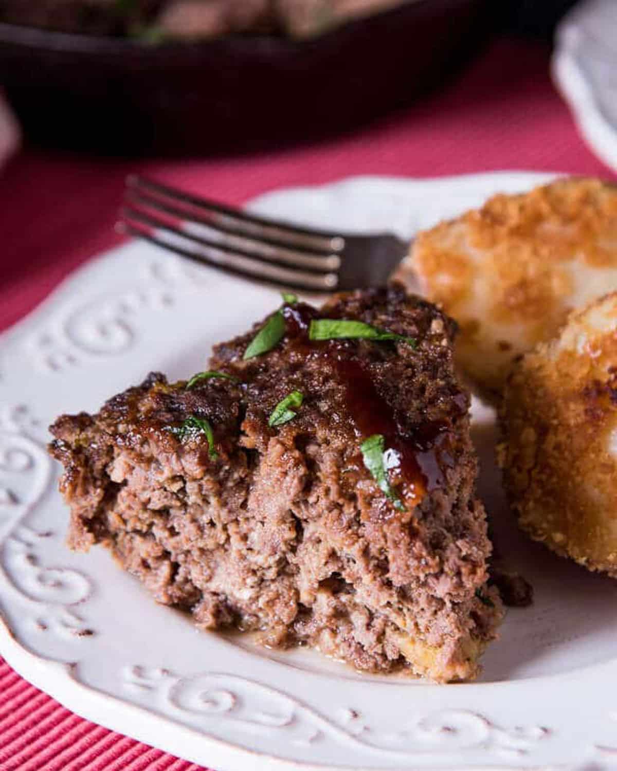 a piece of meatloaf on a plate with a fork