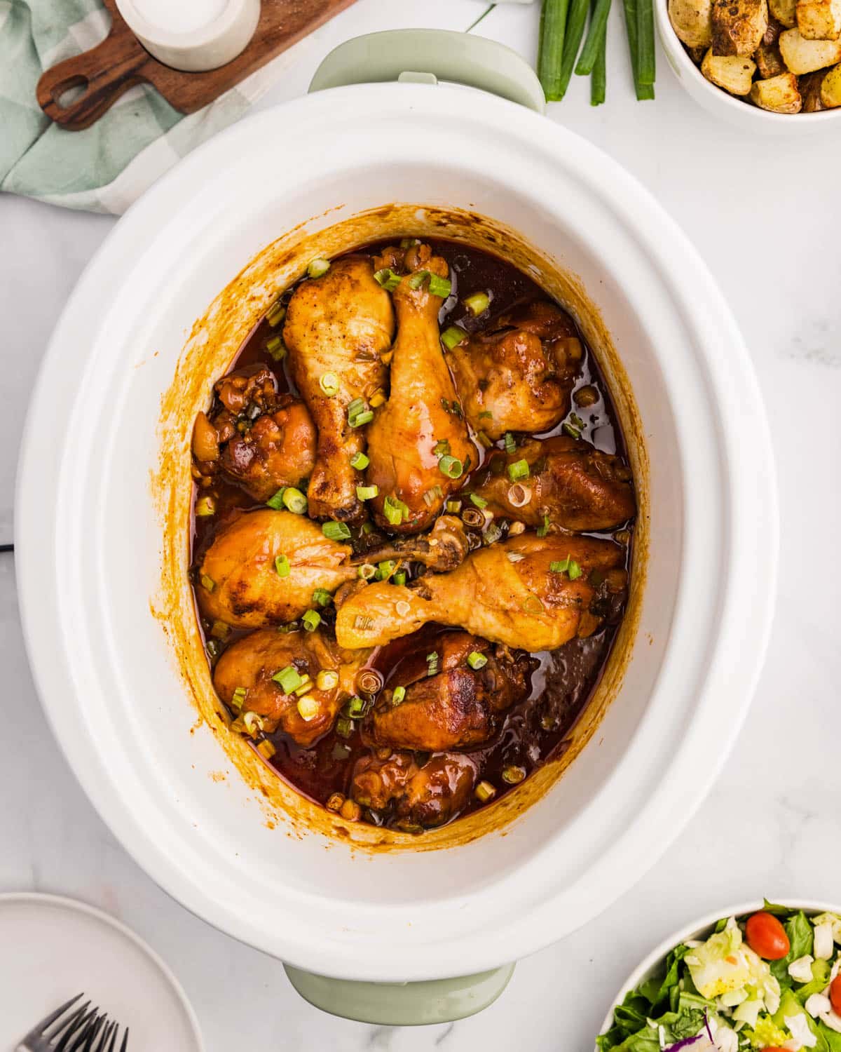 cooked chicken drumsticks in a slow cooker