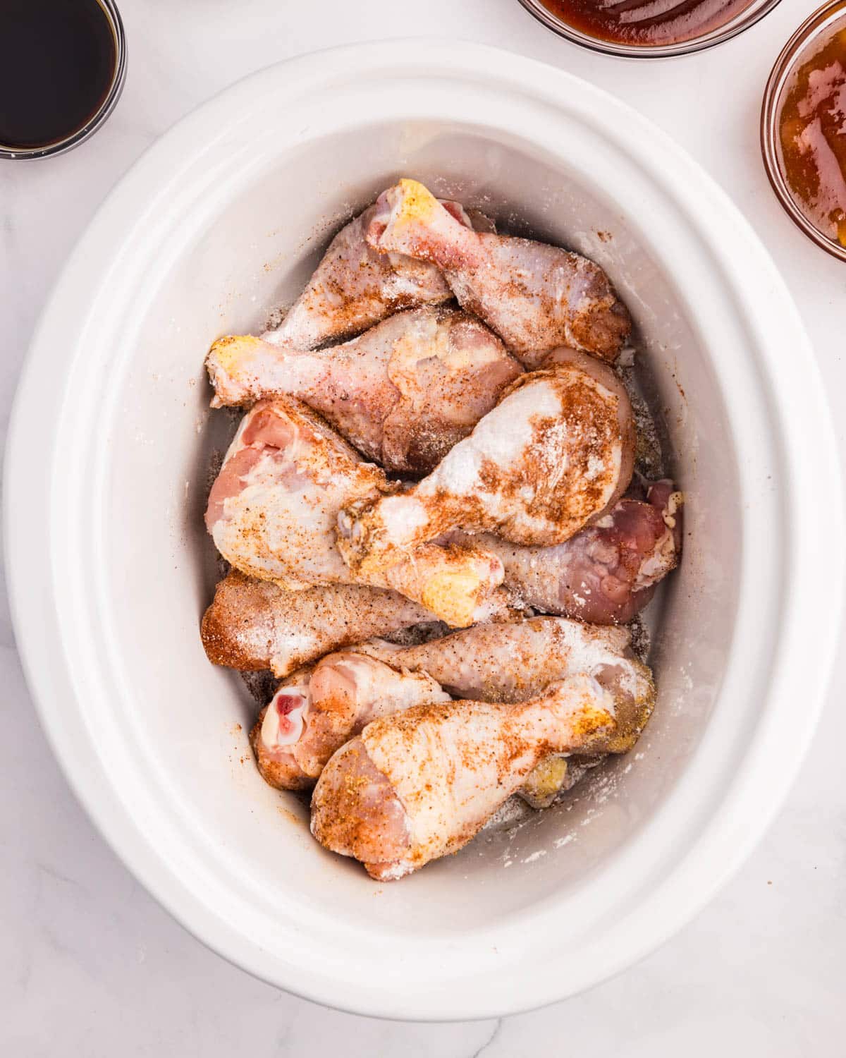 seasoned, uncooked drumsticks in a crockpot