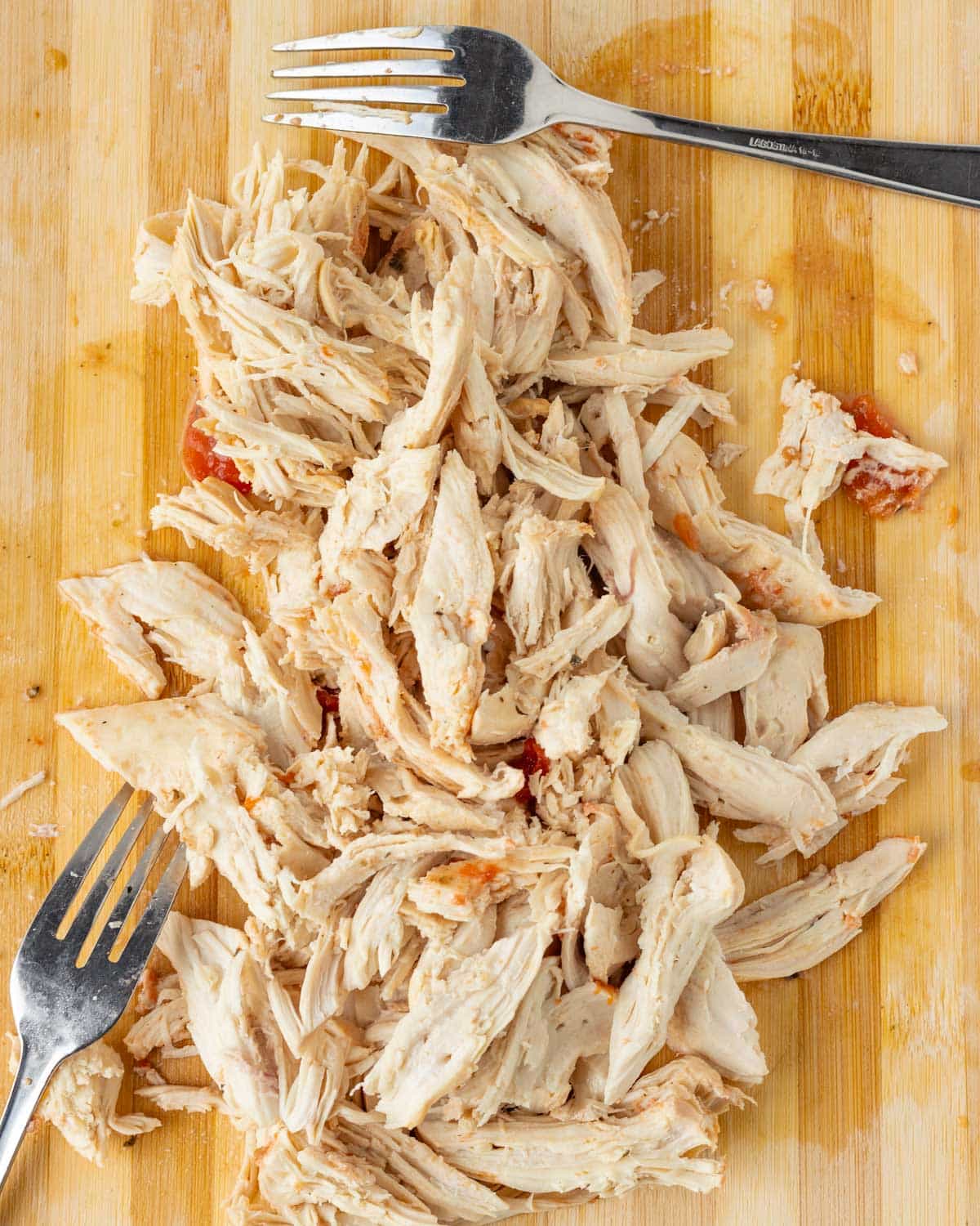 shredded chicken on a cutting board