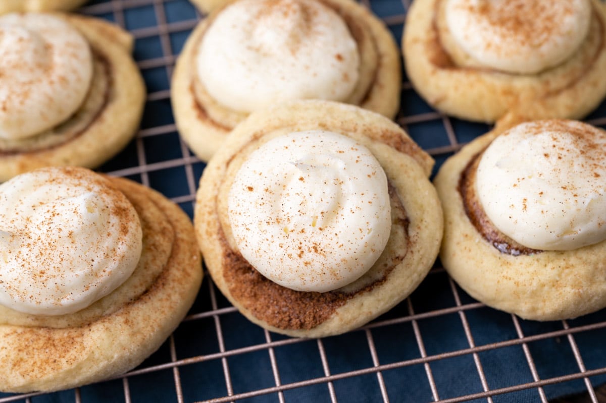 frosted cinnamon roll cookies on a wire rack