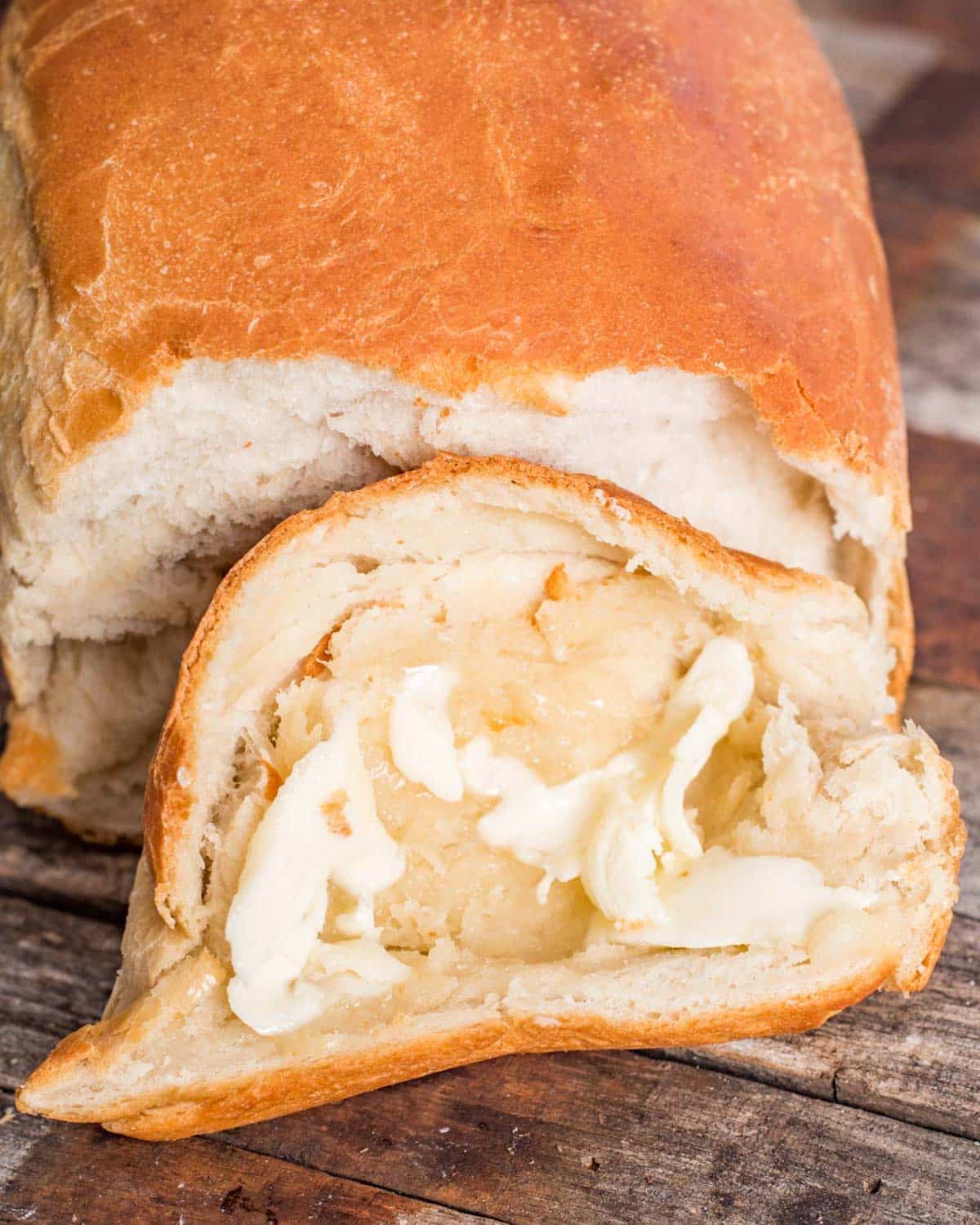 closeup of a soft piece of sourdough discard bread with butter