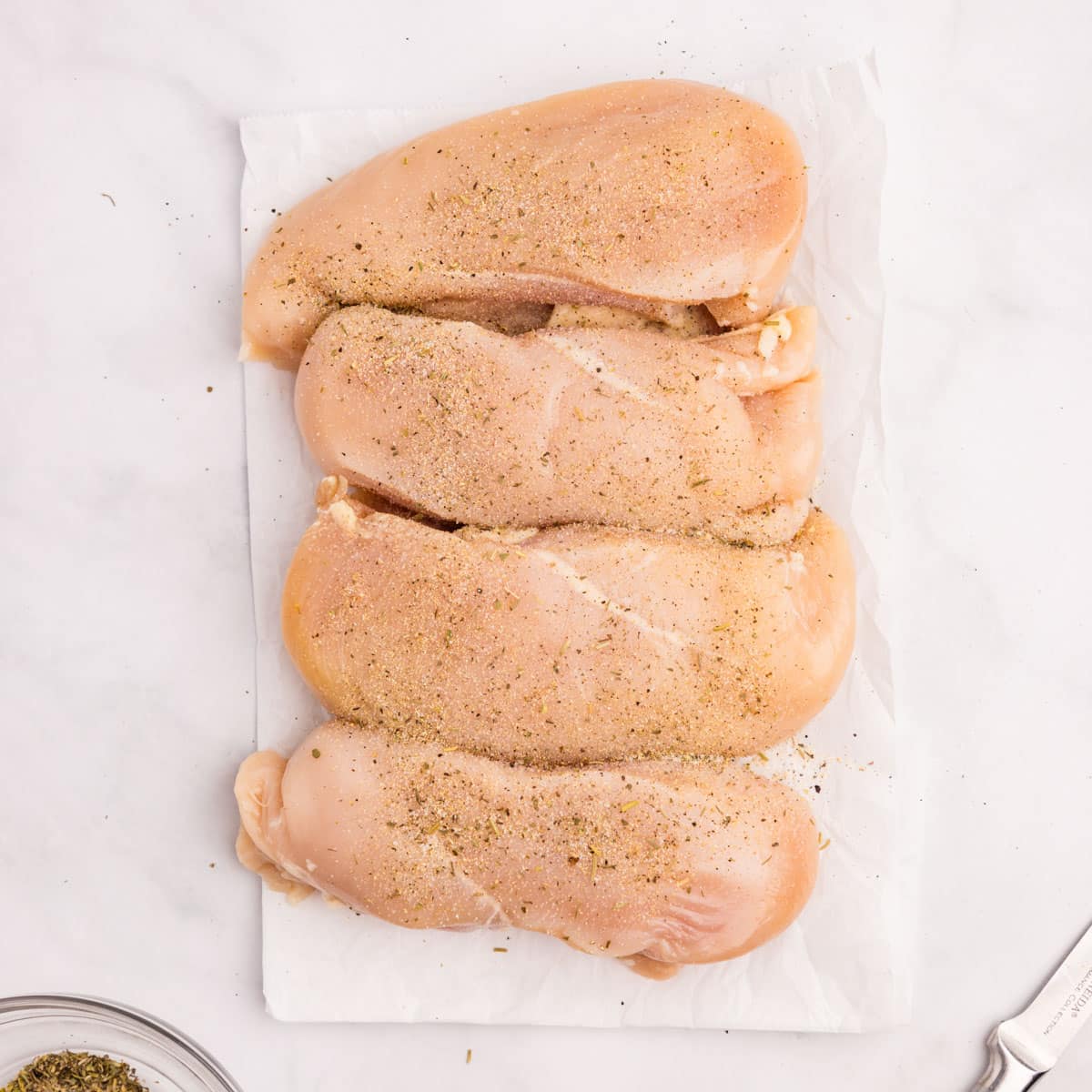 seasoned chicken breasts on a counter