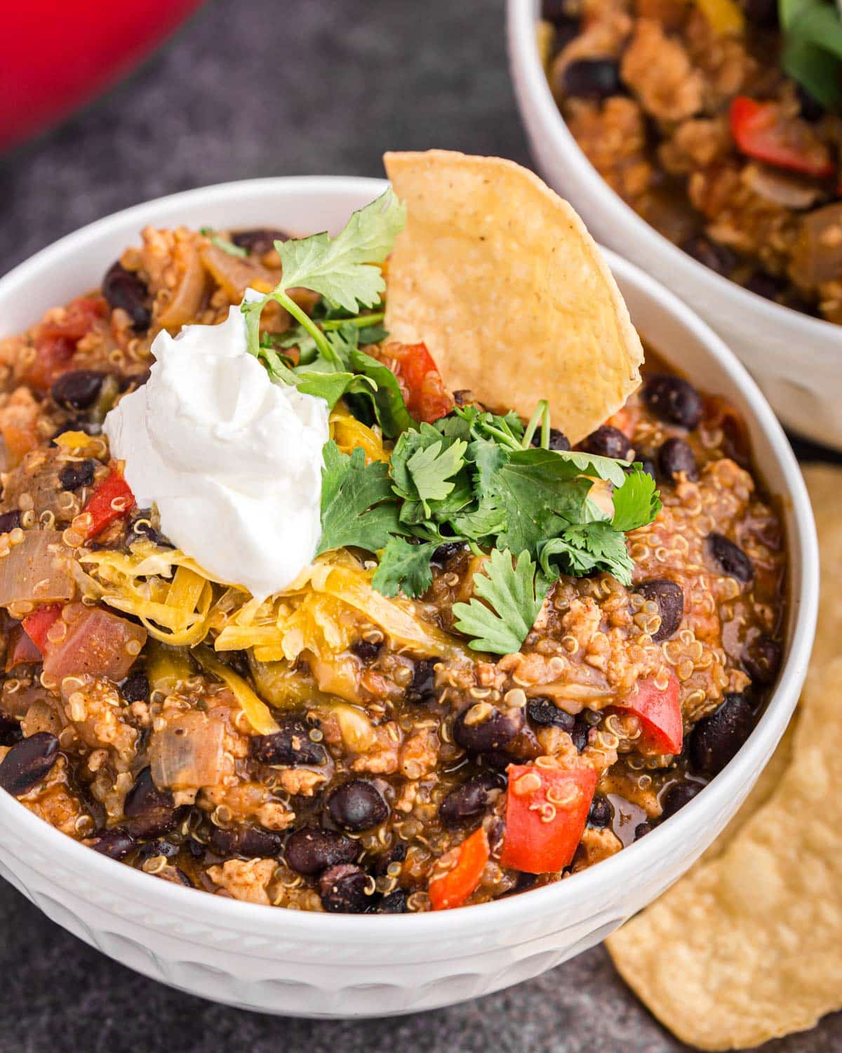 a bowl of black bean chicken chili with toppings