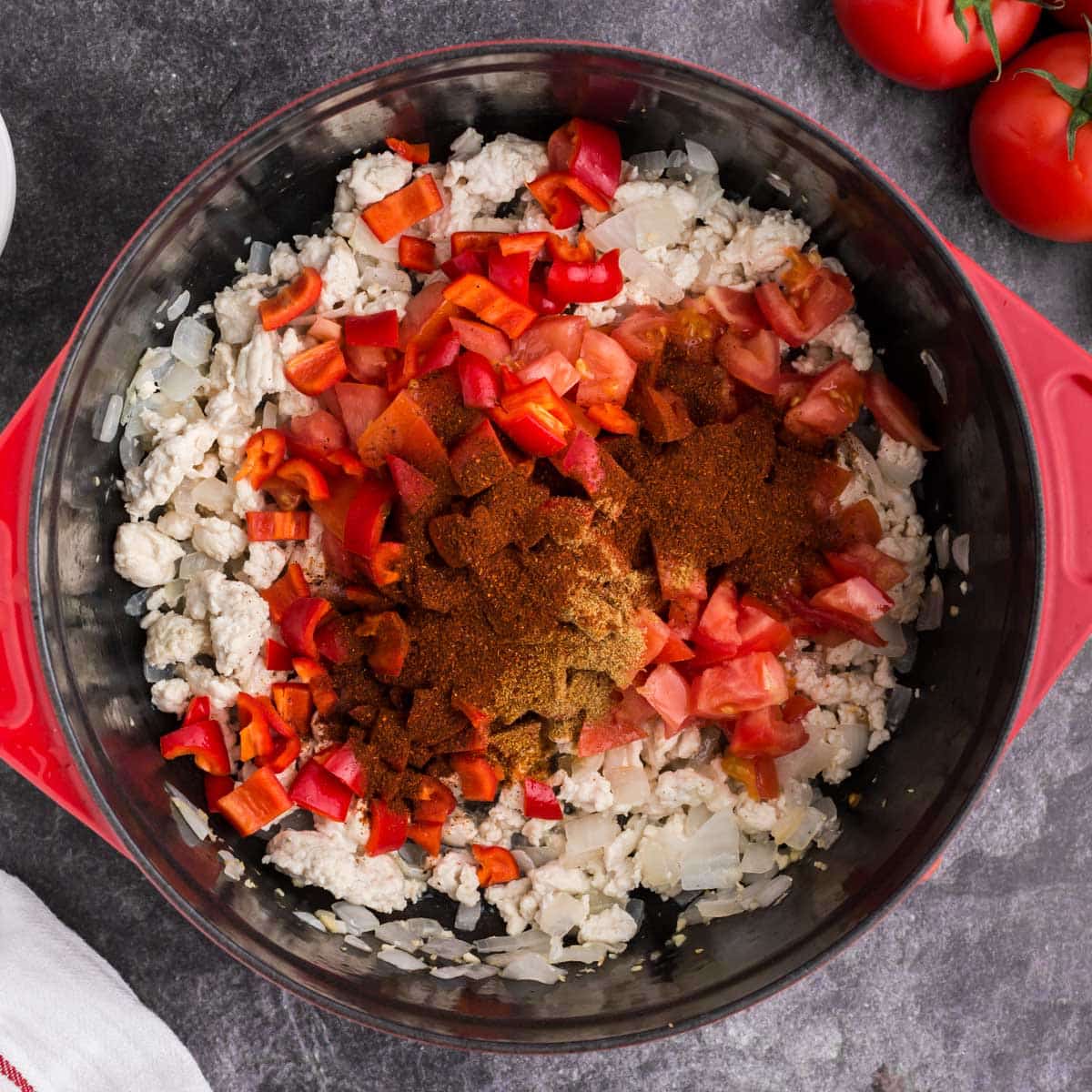 chicken, tomatoes, onions and seasonings in a pot