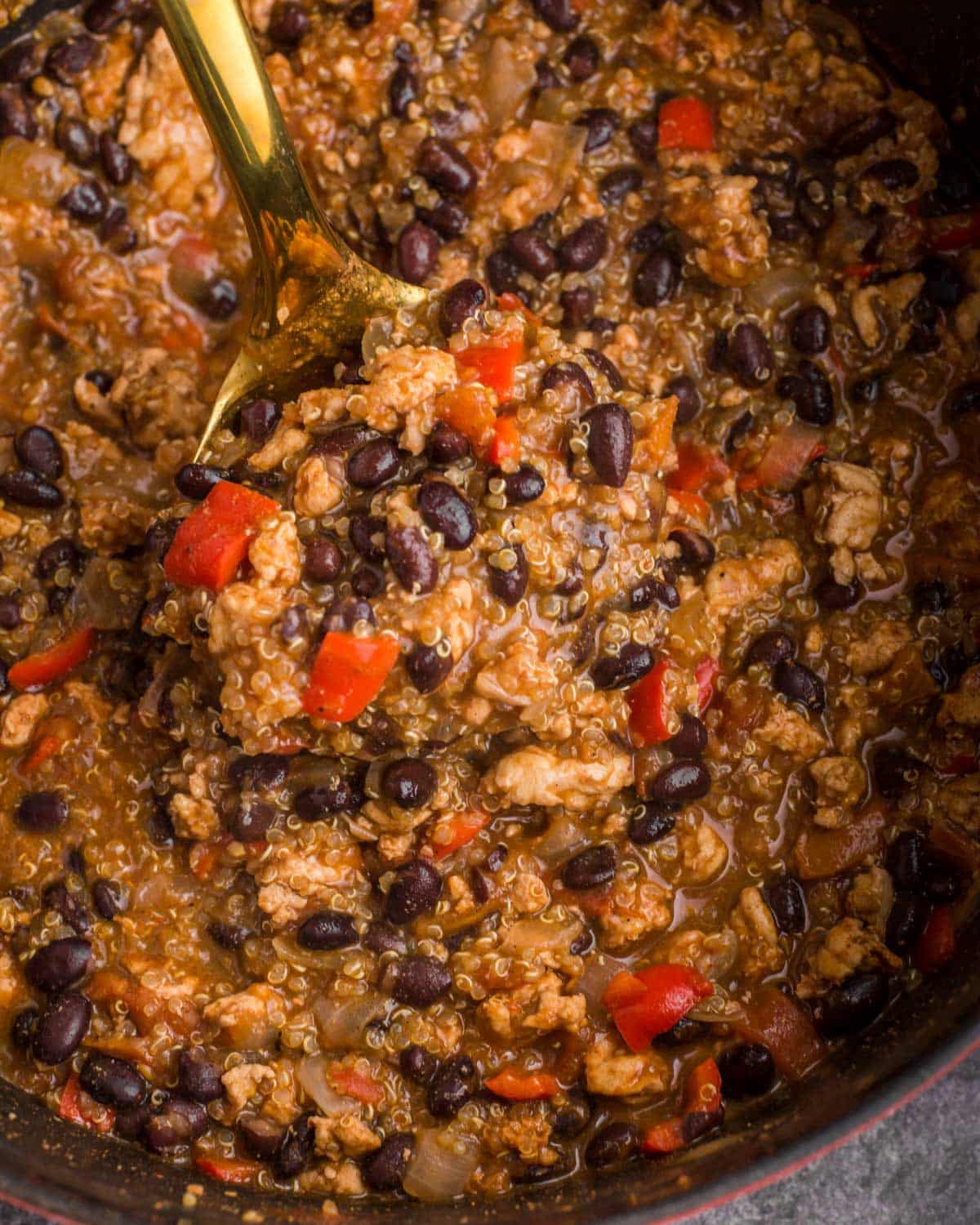 a ladle of black bean chicken chili in a pot