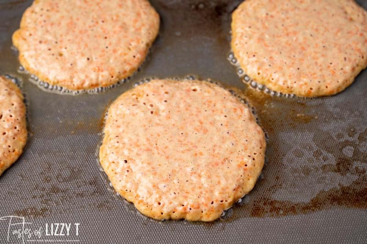 pancakes cooking on a griddle