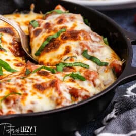 italian skillet chicken with a spoon in it