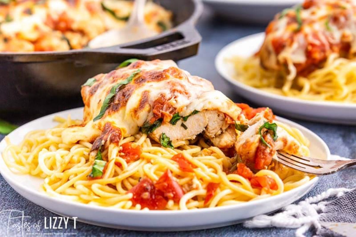 a plate of italian skillet chicken with spaghetti