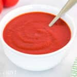 pizza sauce with tomato puree in a bowl with a spoon