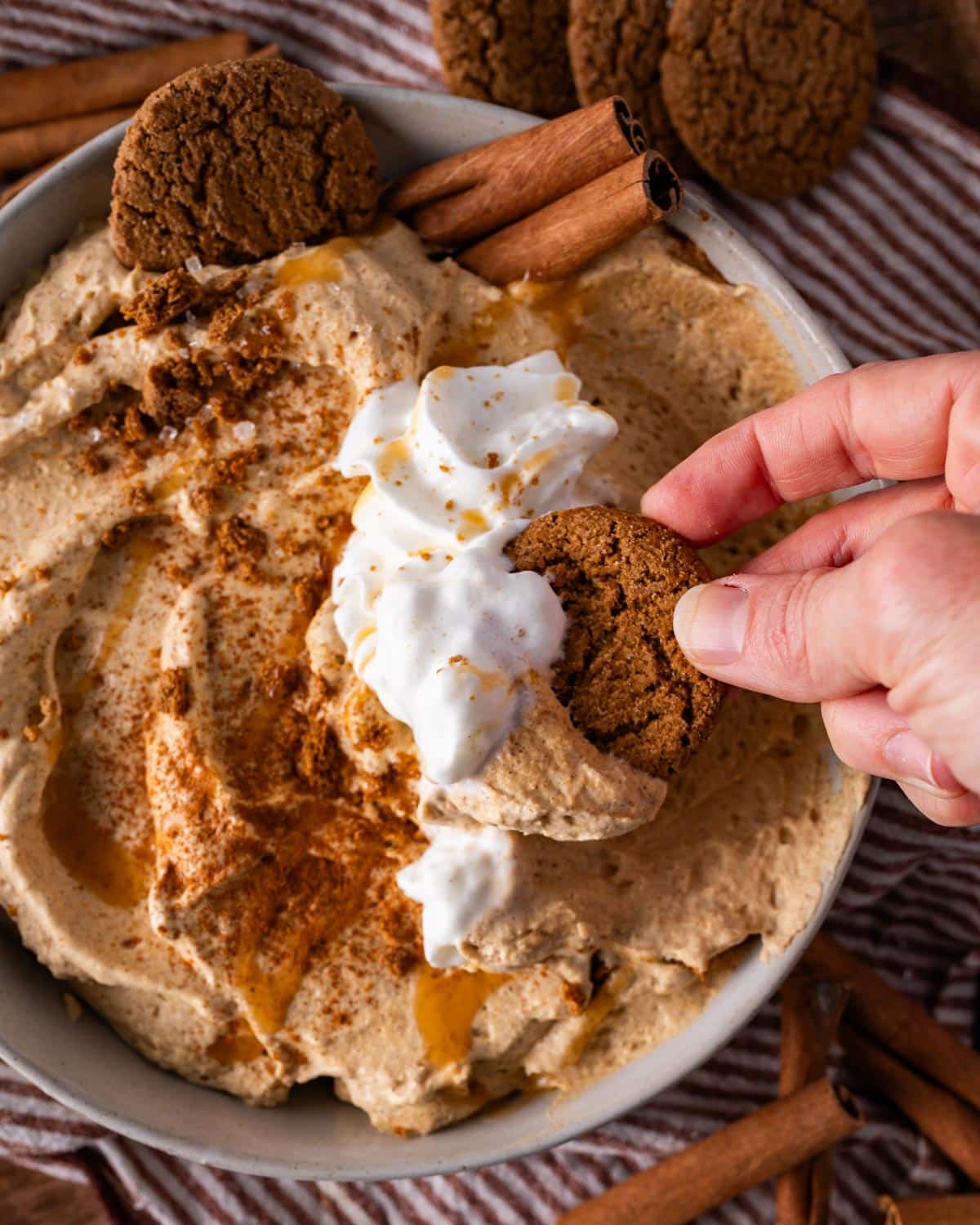 gingerbread cookie scooping into pumpkin pie dip