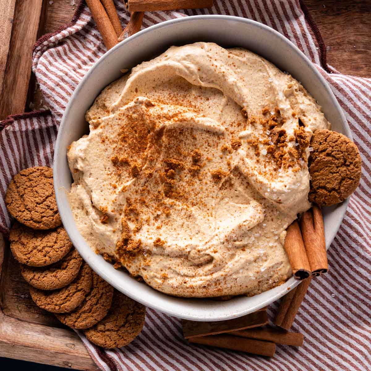 pumpkin pie dip in a bowl with crushed gingersnap cookies