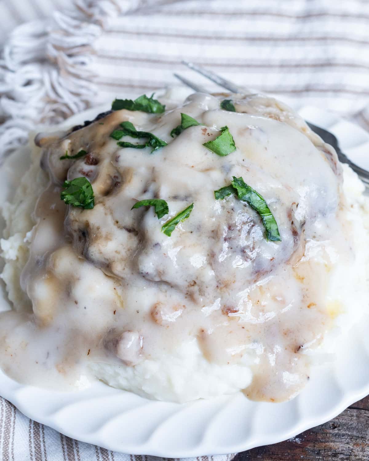 a plate of salisbury steak with mashed potatoes