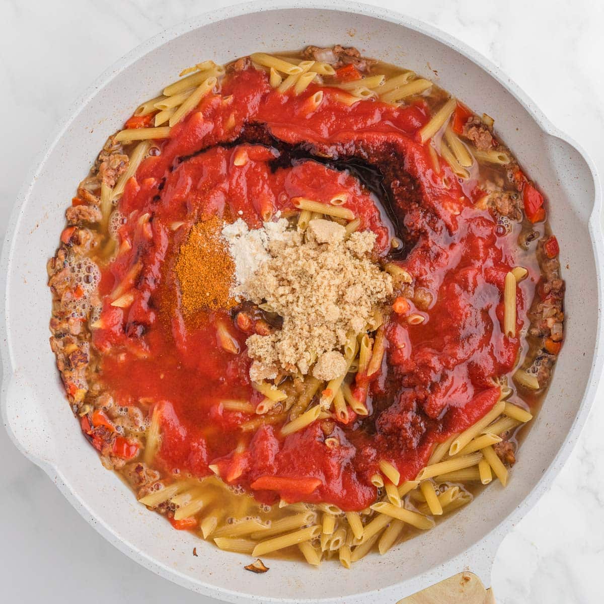 ingredients for sloppy joe pasta in a deep skillet