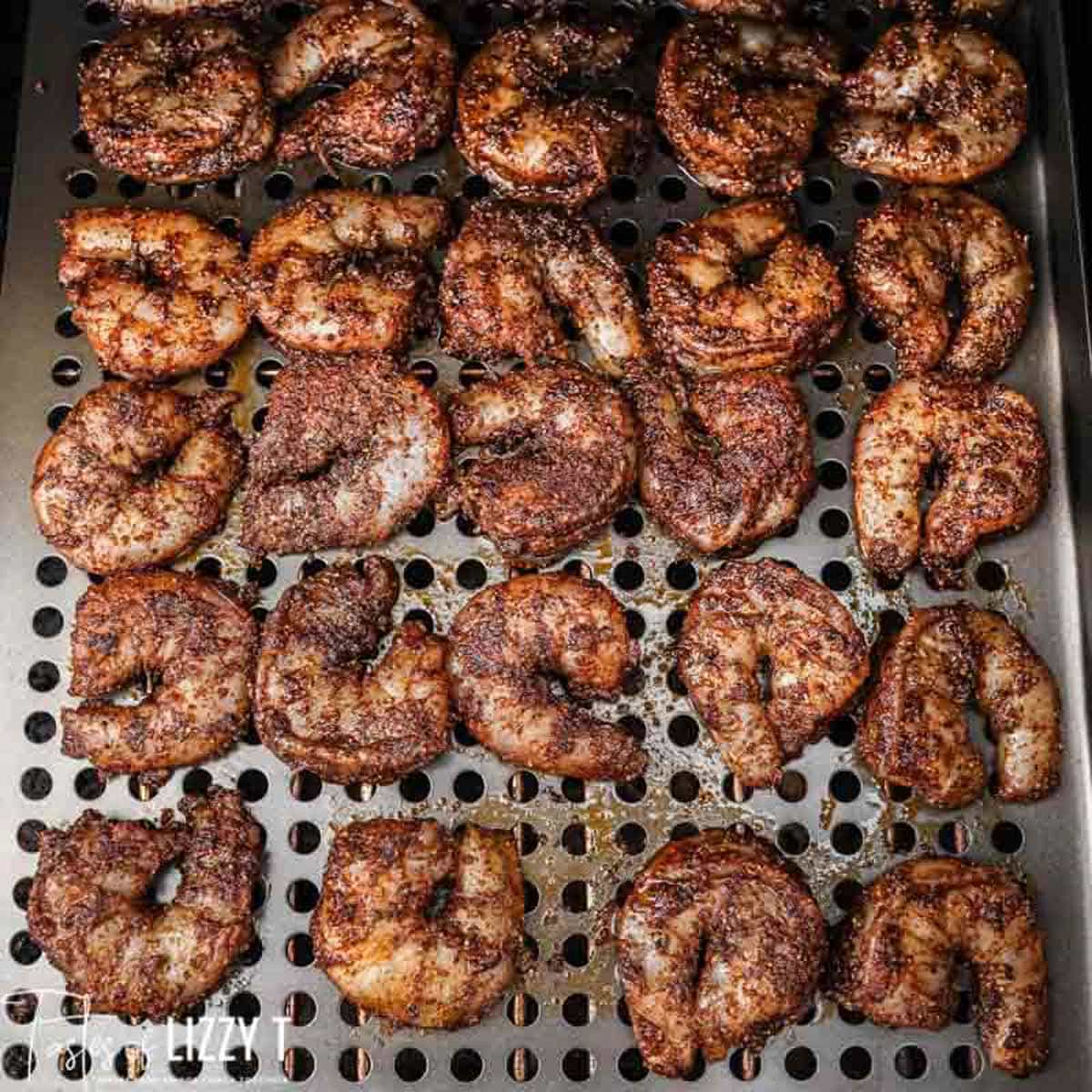 uncooked shrimp on a grate