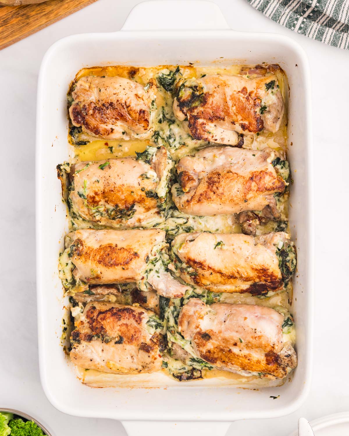 overhead view of stuffed chicken rolls in a pan