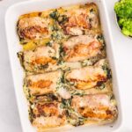 a pan of stuffed chicken thighs with spinach and cheese